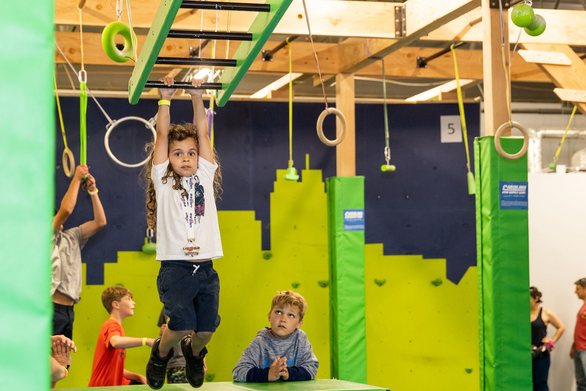 A group of children are playing in a gym.