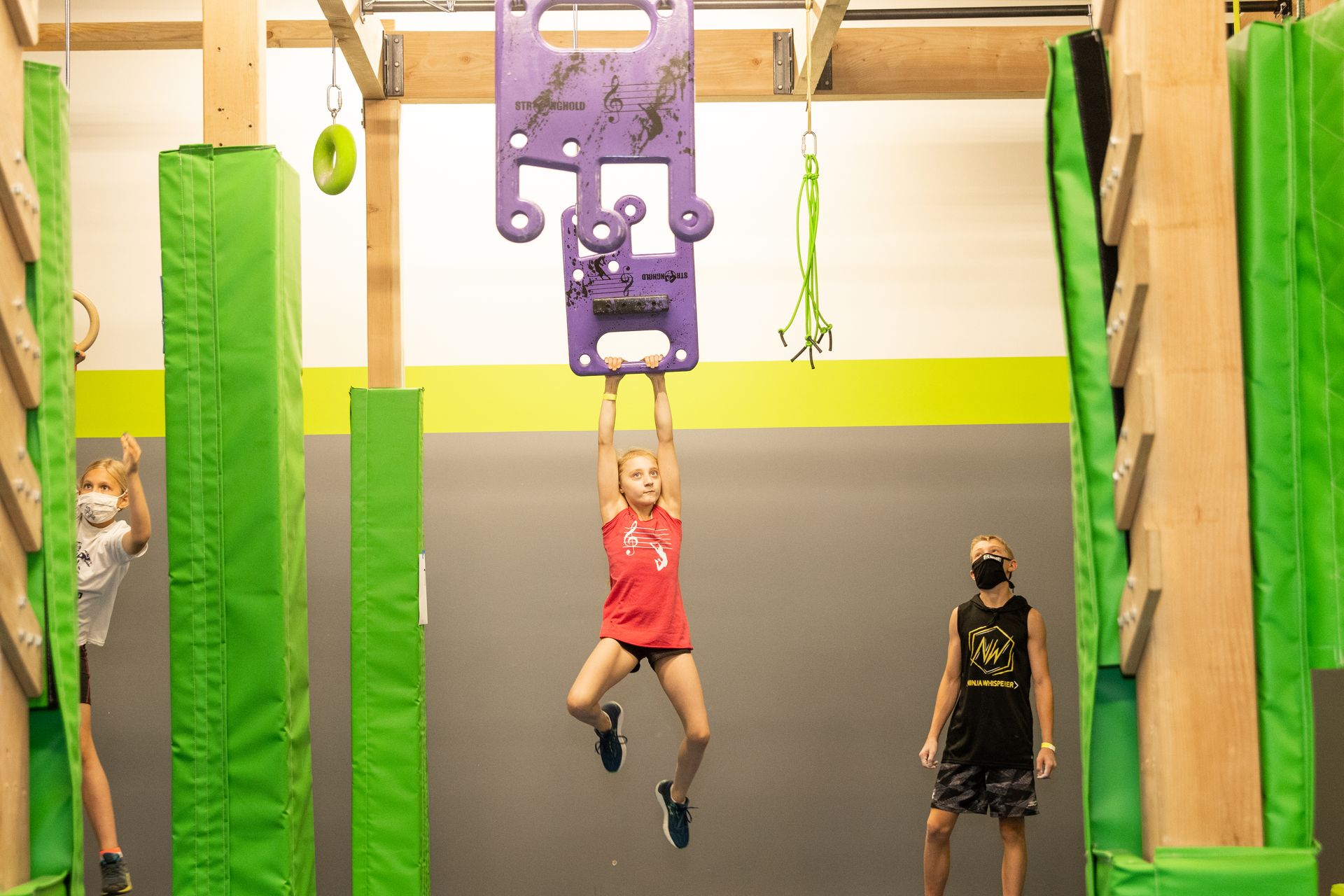 A group of children are playing in a gym.