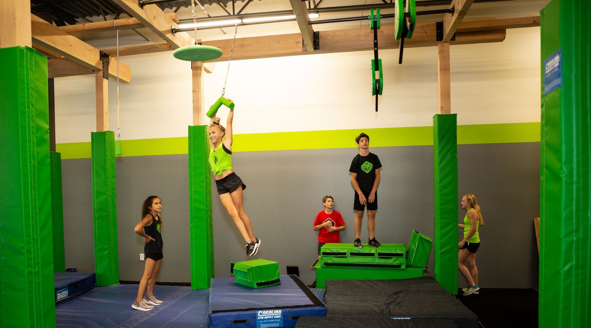 A group of children are playing in a gym.