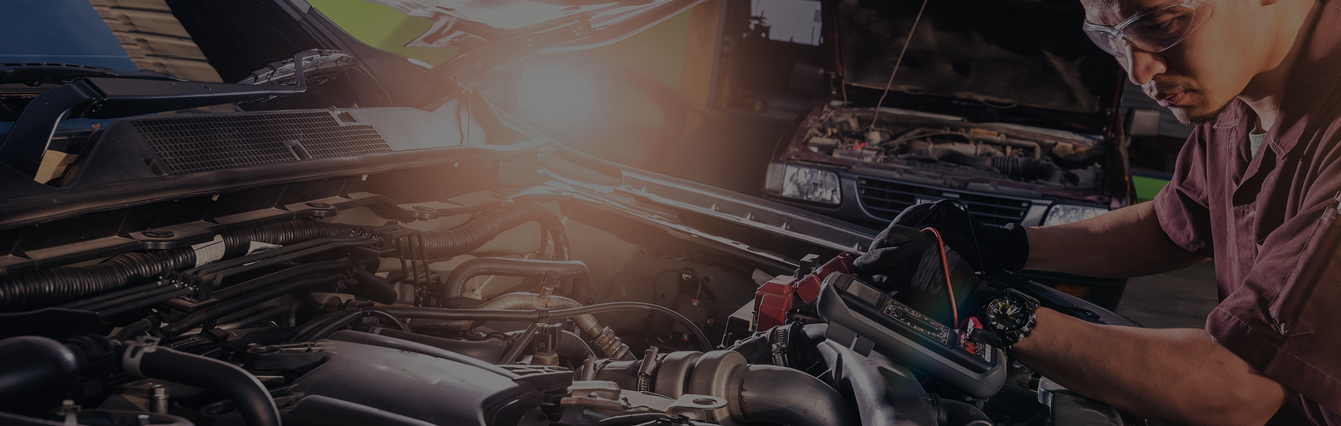 A person is working on the engine of a car in a garage | B & K Collision
