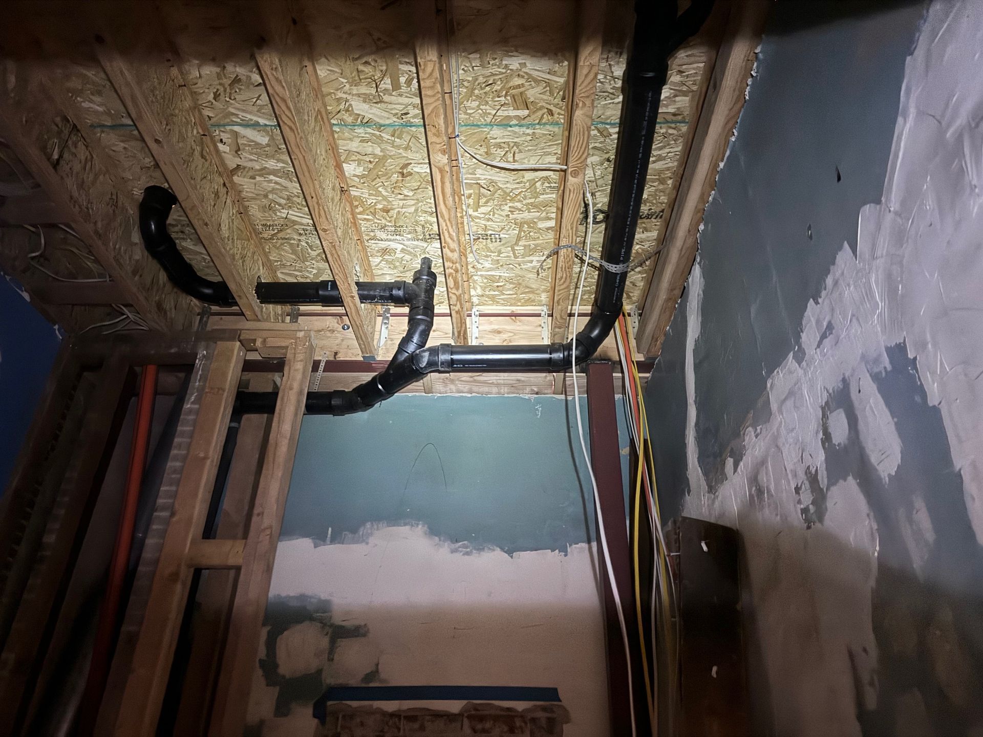 A room with a lot of pipes hanging from the ceiling