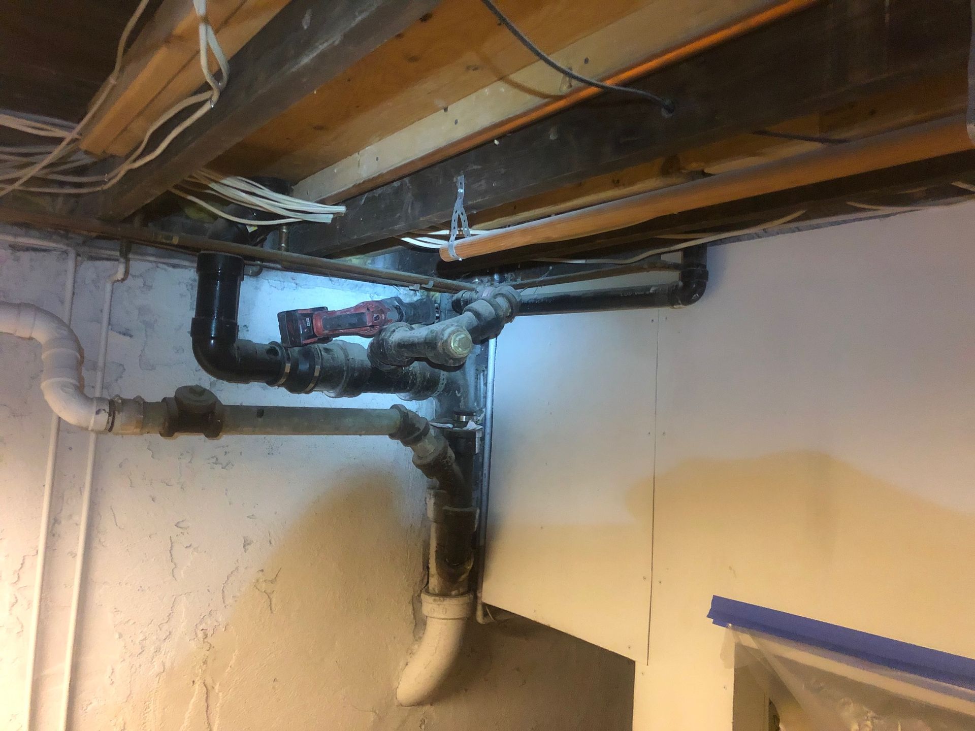 A bunch of pipes are hanging from the ceiling of a room.