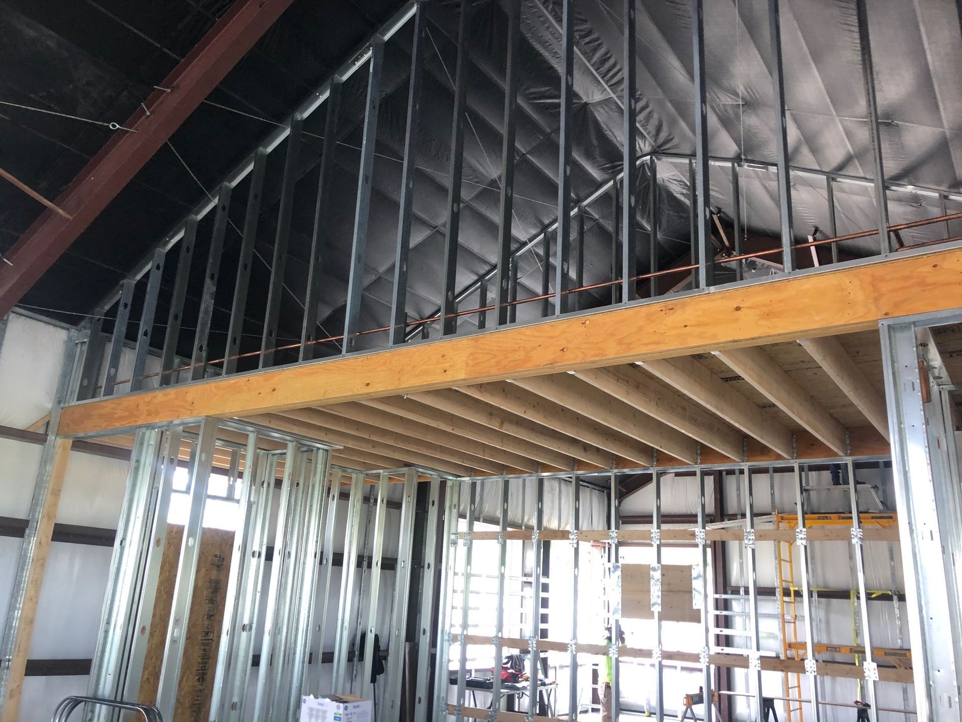 The inside of a building under construction with a wooden floor.