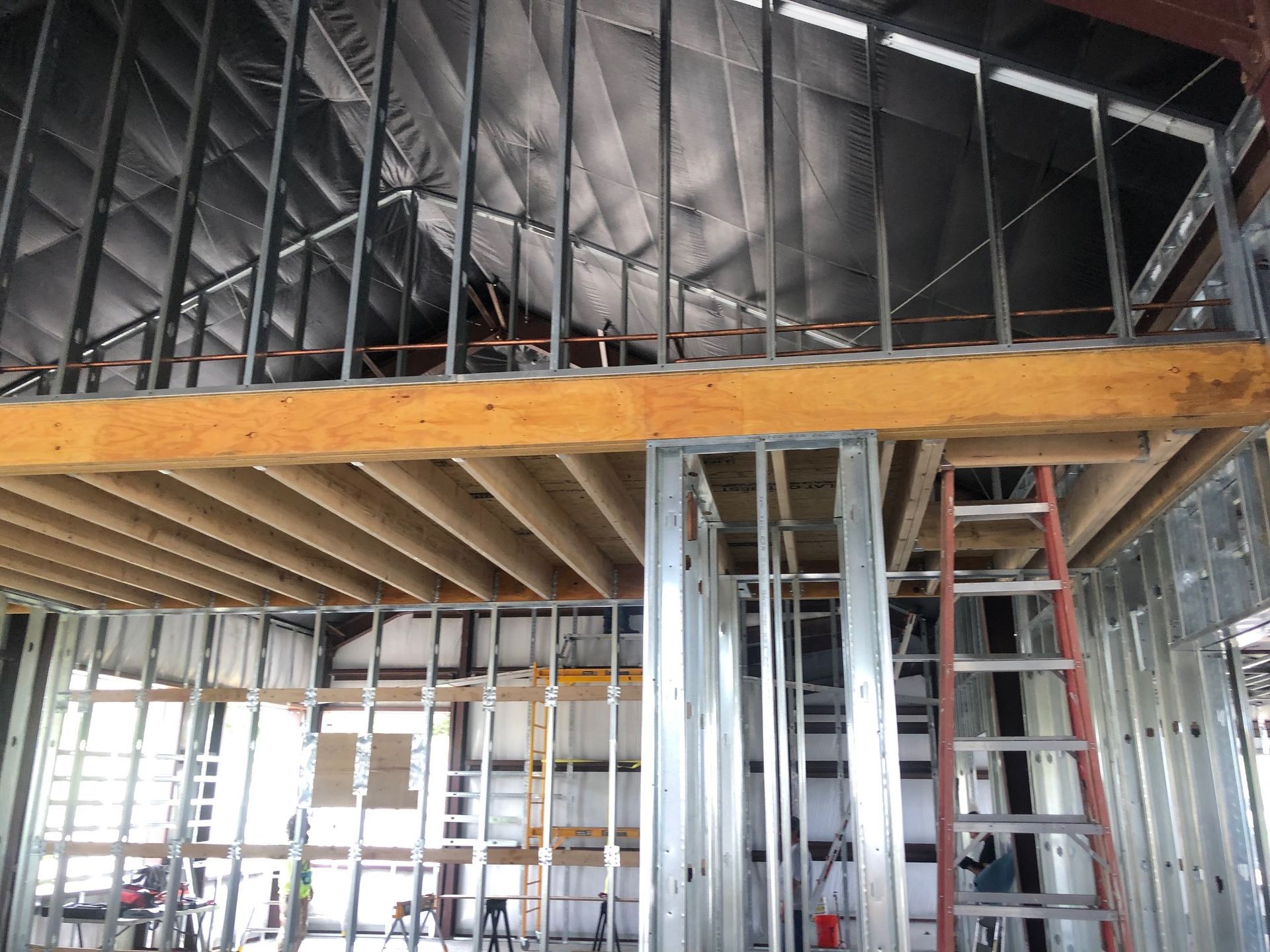 A building under construction with a ladder in the middle