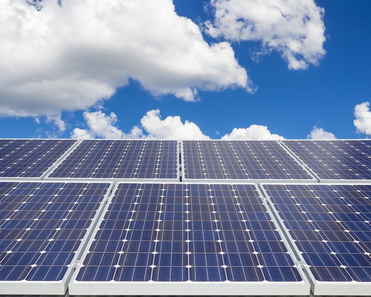 Solar Panels Against A Blue Sky With Clouds — Experienced Solar Installers in Tamworth