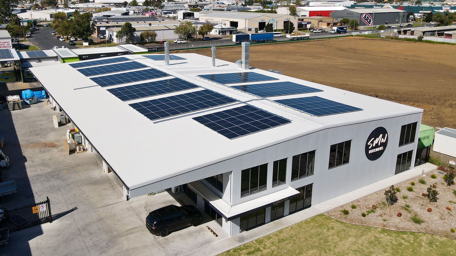 An Aerial View Of A Building With Solar Panels On The Roof — Experienced Solar Installers in Tamworth
