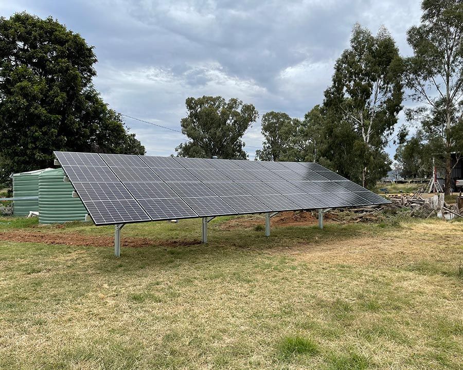 Solar Panels Installed on a field with trees in background — Experienced Solar Installers in Tamworth
