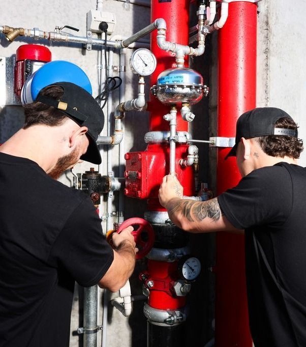 Men fixing valves and pipes