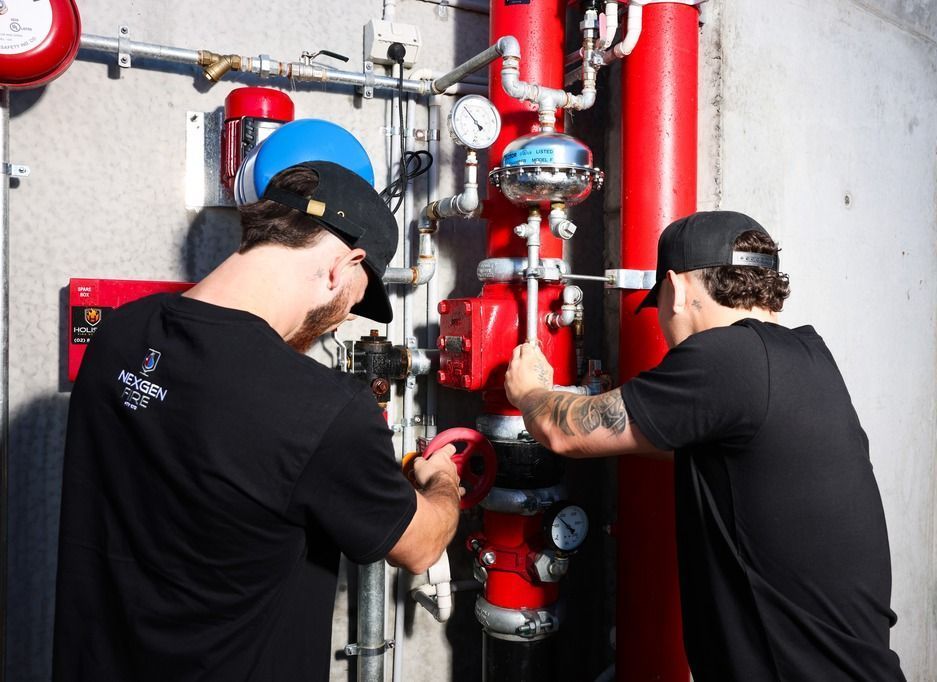 Men fixing valves and pipes