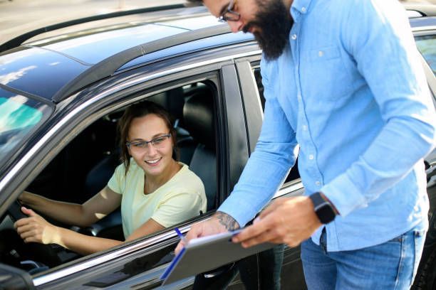 A Man Is Talking To A Woman In A Car — Leesburg, GA — DOCO Driving School