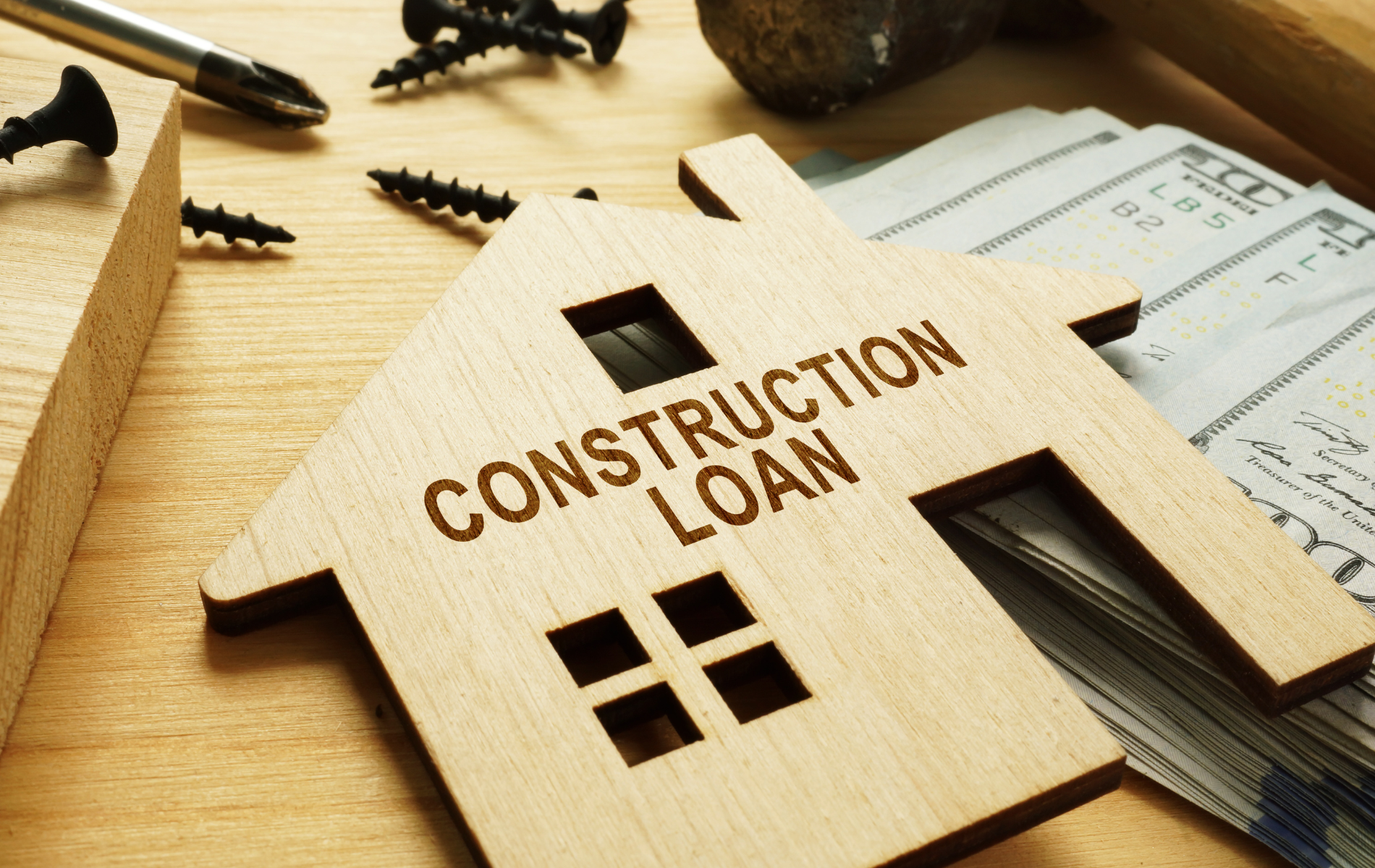 A wooden house with the words construction loan written on it