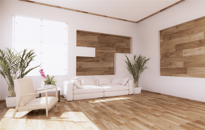 A living room with a white couch , chair , and wooden floor.