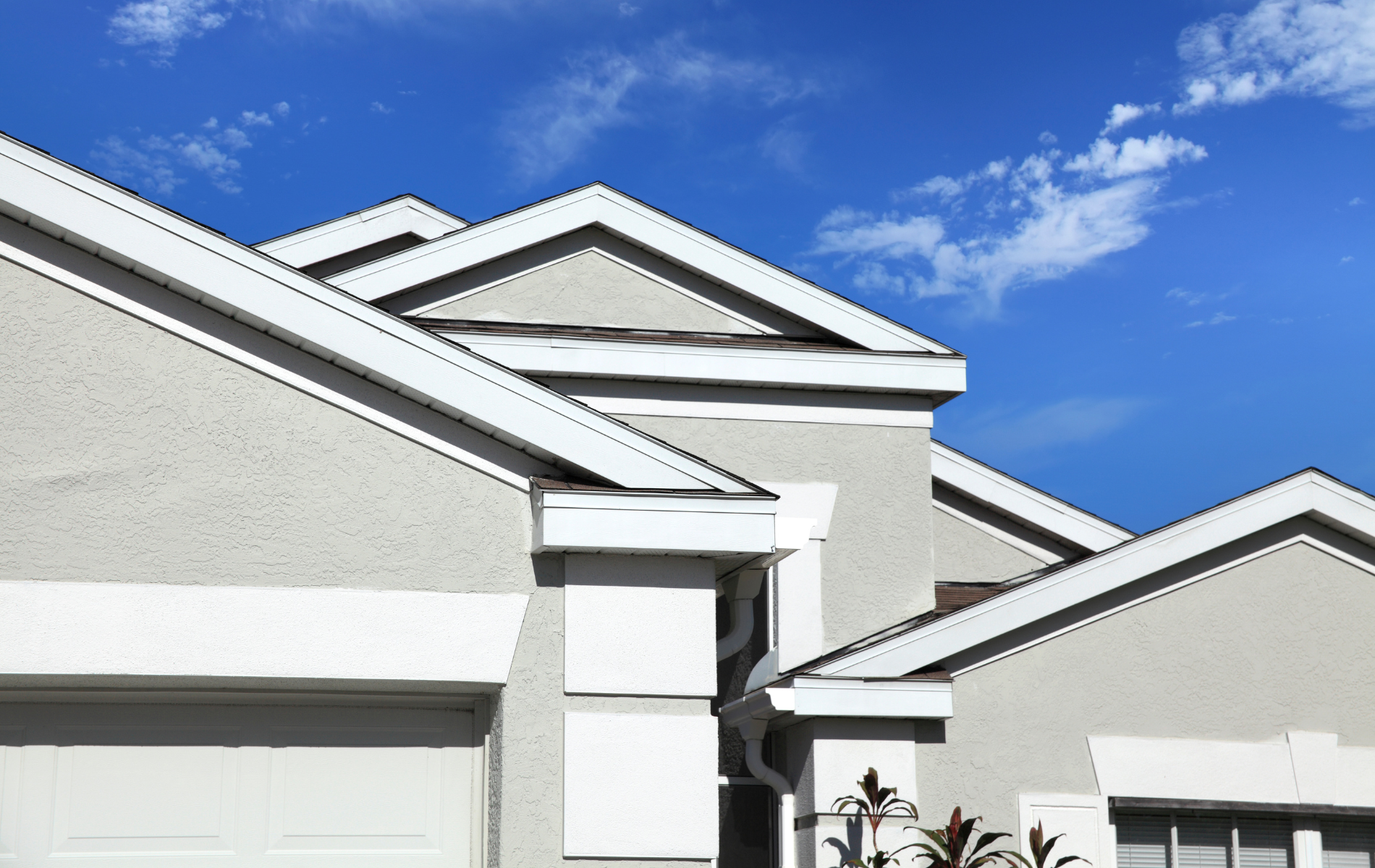 A row of houses with a blue sky in the background.