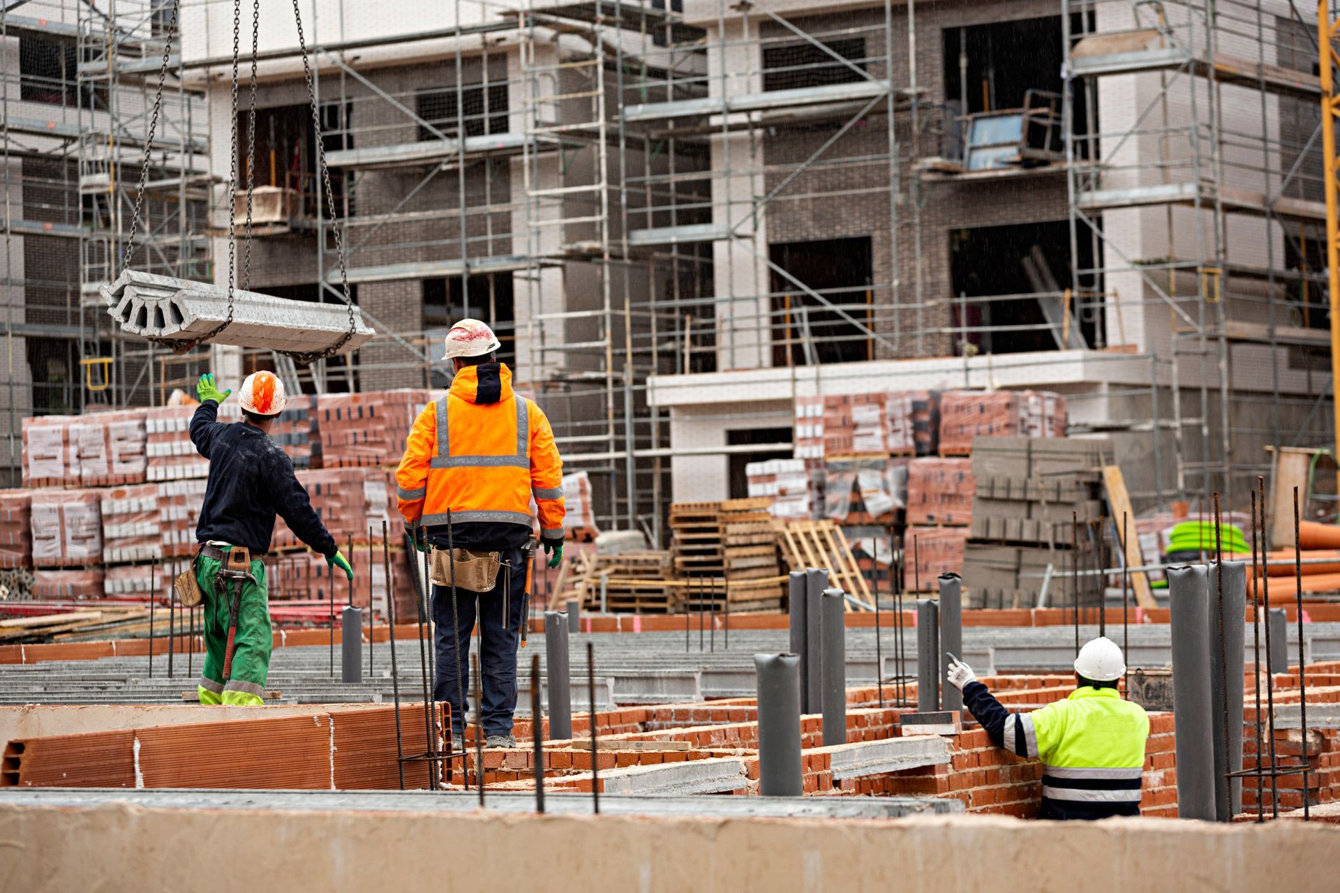 Tradespeople working on an active construction site, representing trade and industrial workforce roles
