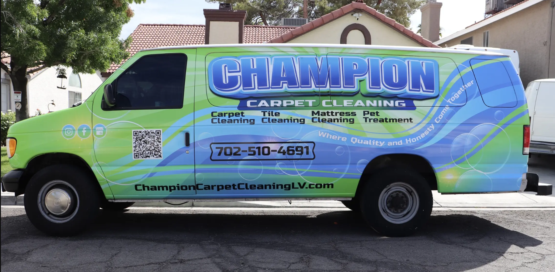 A champion carpet cleaning van is parked in front of a house
