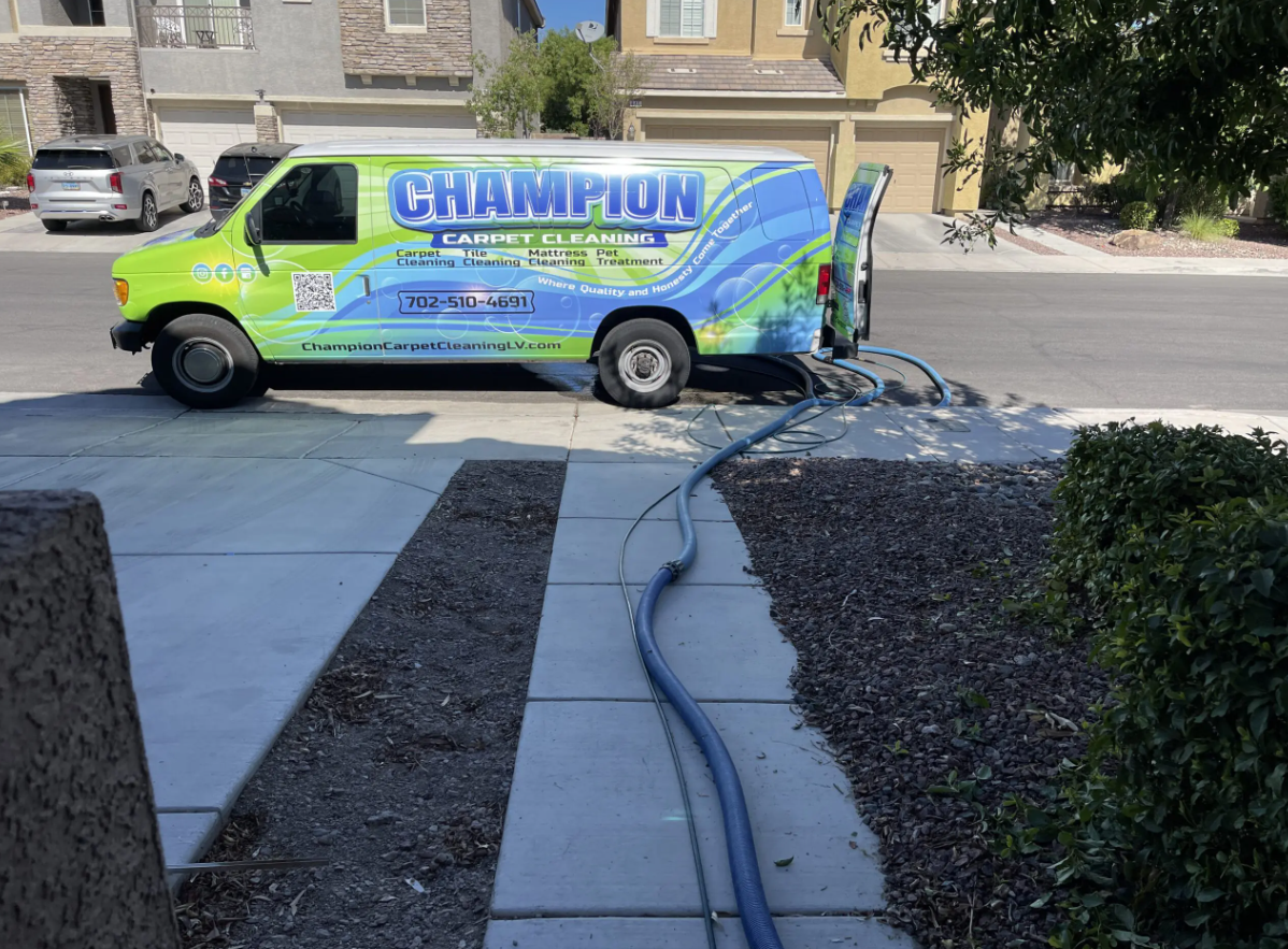 A champion van is parked on the side of the road