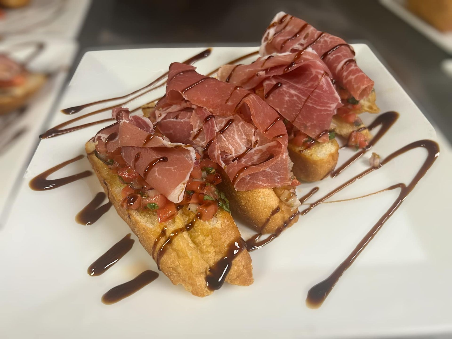 A white plate topped with two slices of bread and meat