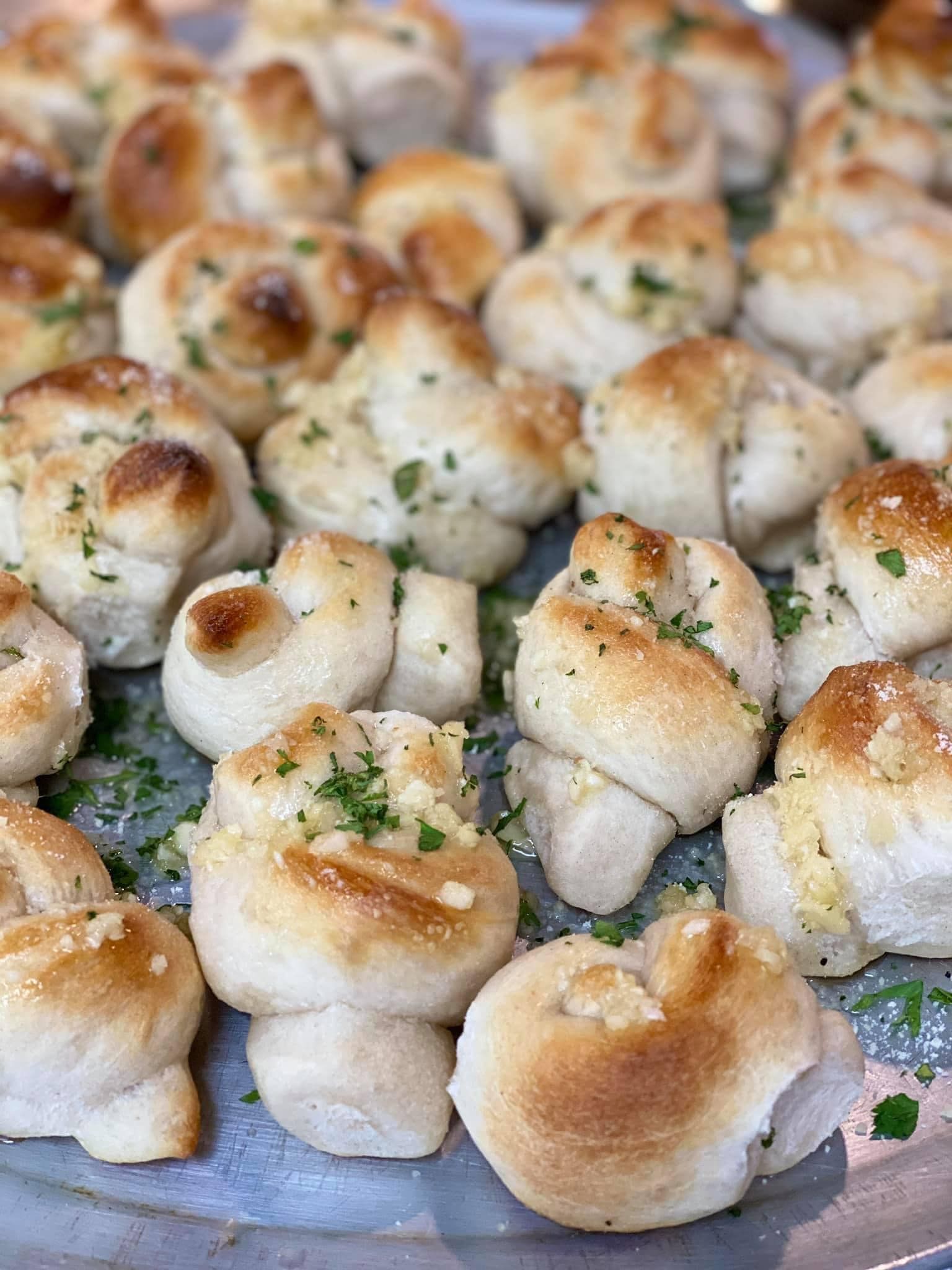 A close up of garlic knots on a plate.
