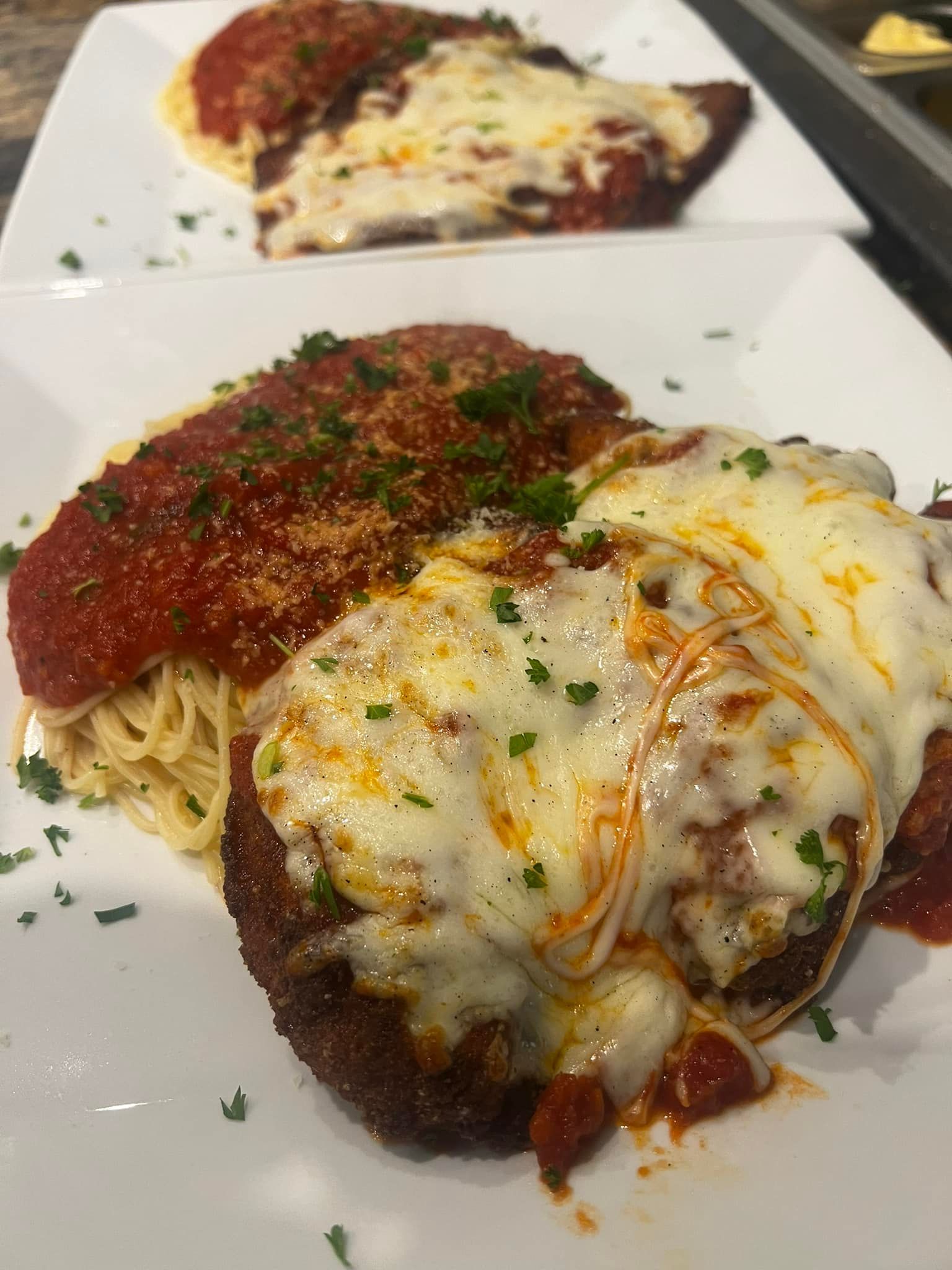 A close up of a plate of food with spaghetti and meatballs on a table.
