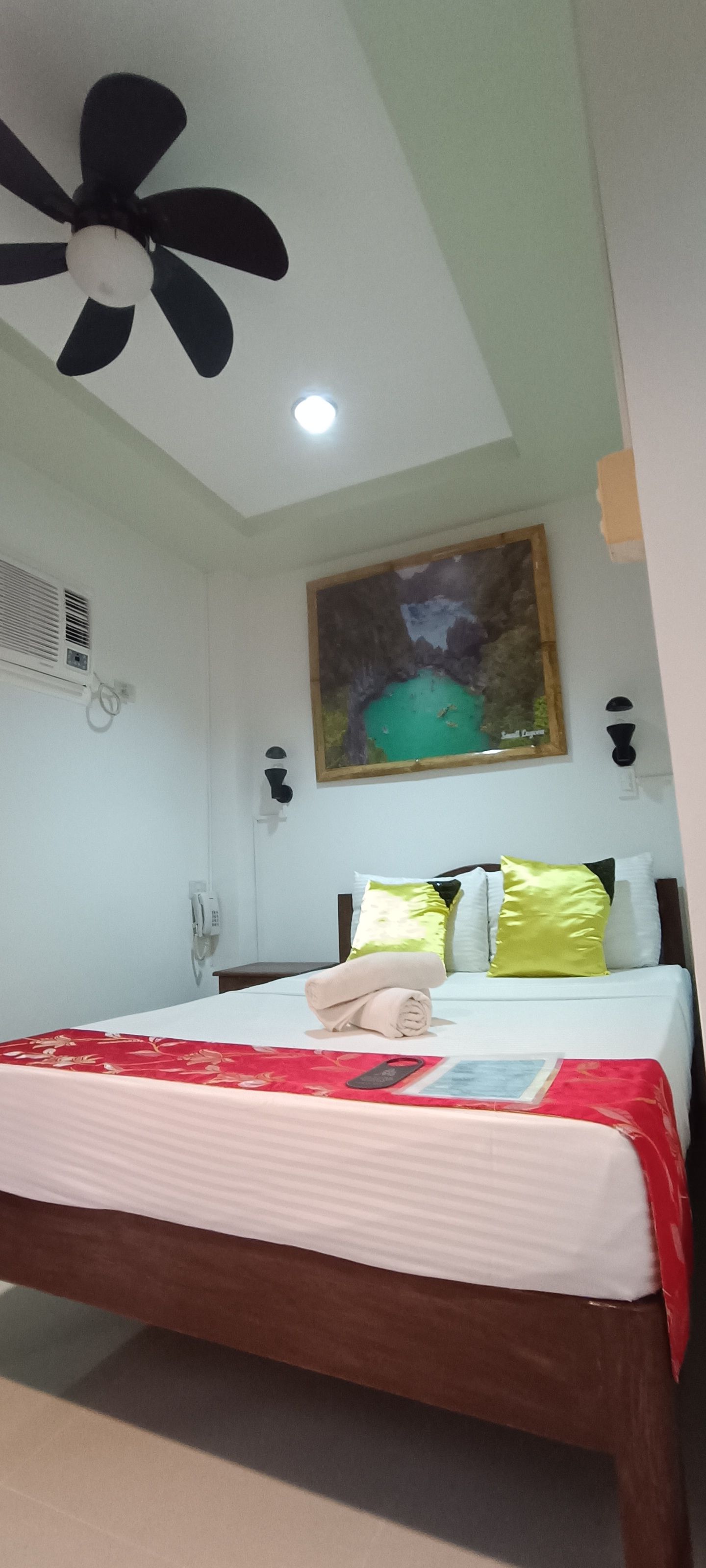 There is a ceiling fan above the bed in the room.