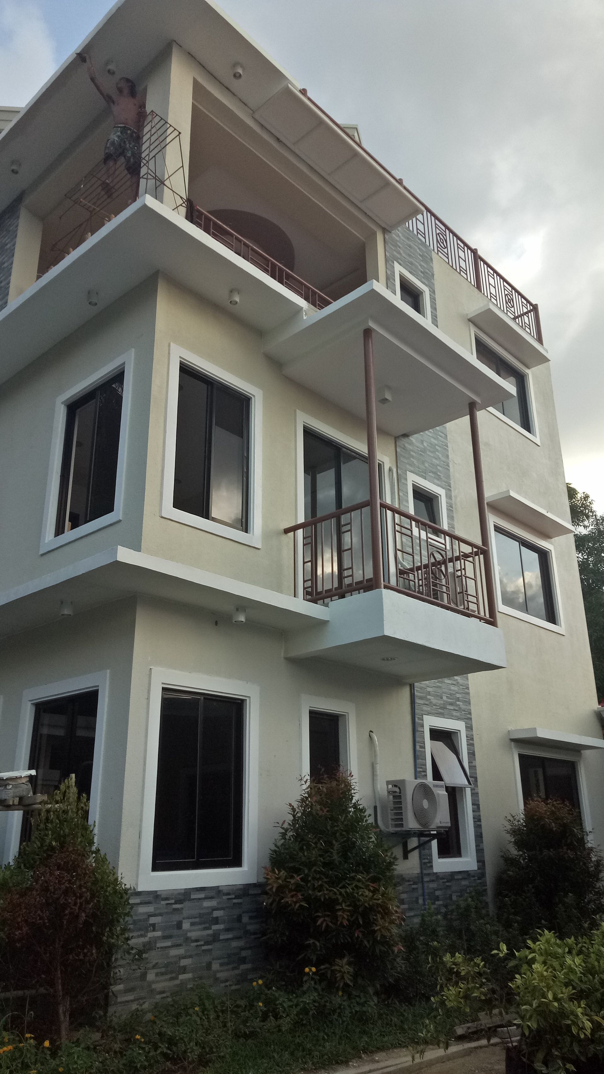 A large white house with a balcony and a lot of windows.