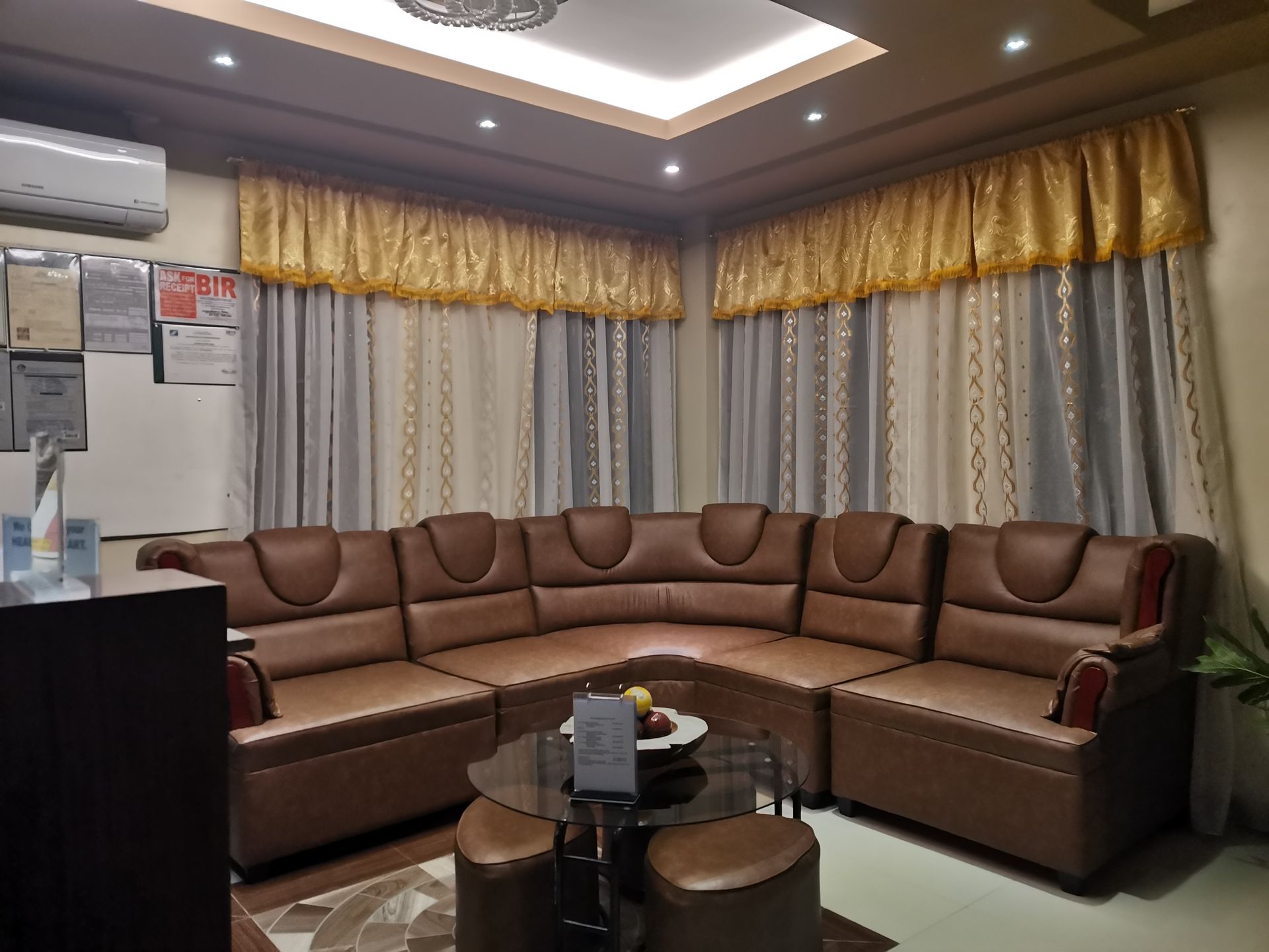 A living room with a large sectional couch and a table