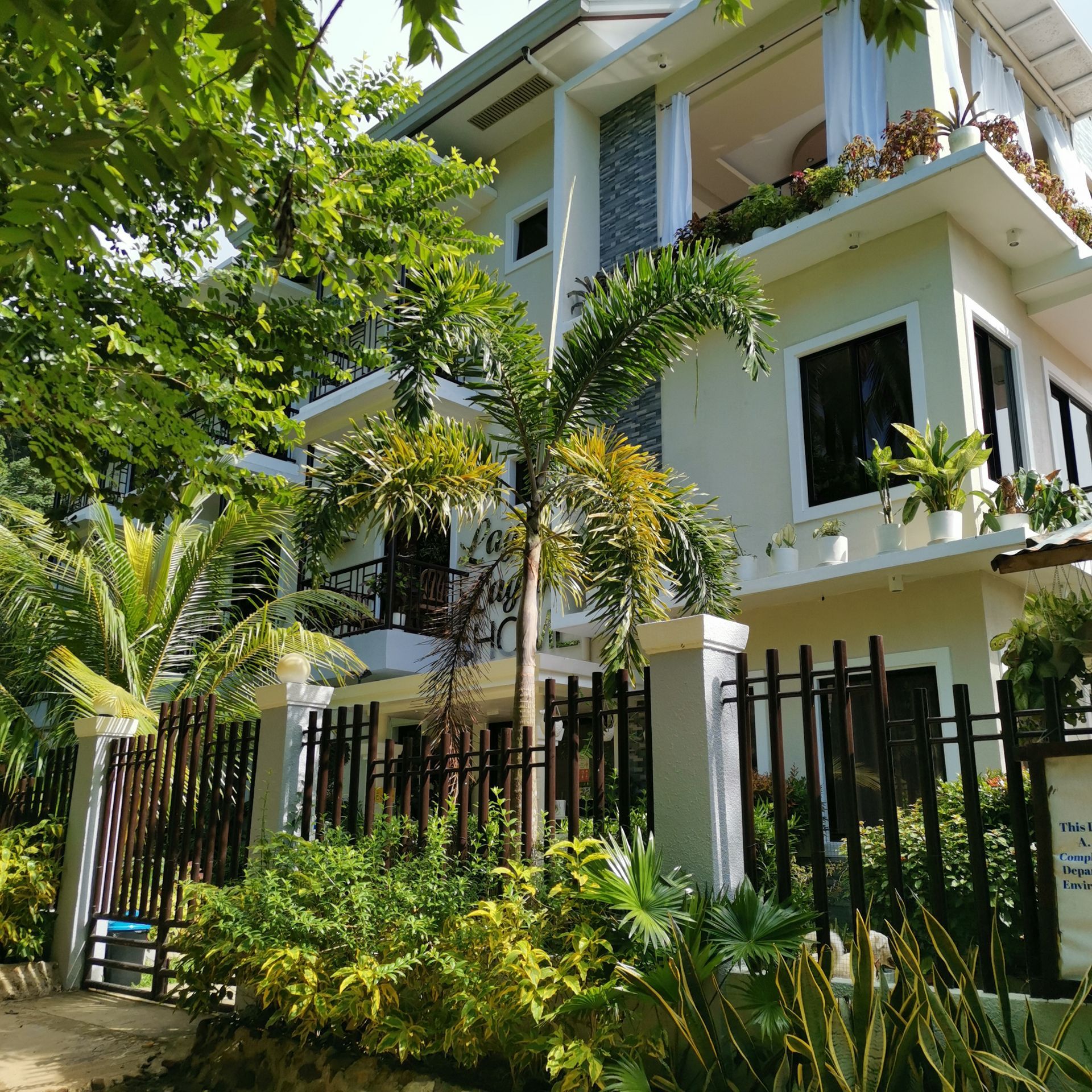 A large white house with a fence around it