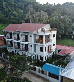 An aerial view of a house with a red roof