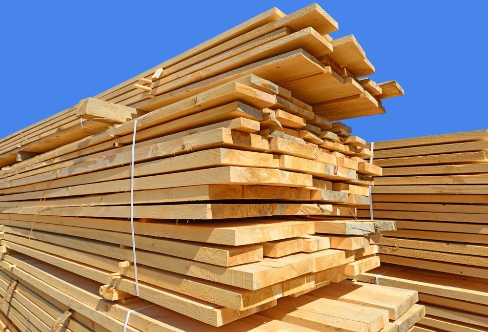A Pile of Wood Is Stacked on Top of Each Other Against a Blue Sky — Budget Timbers in North Lismore, NSW