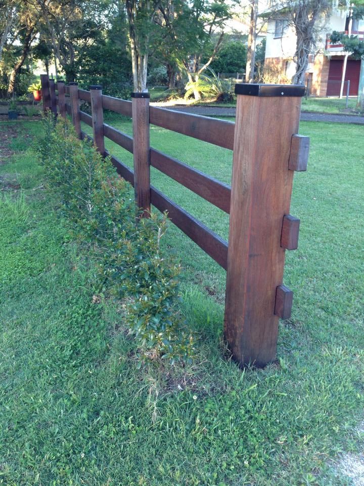 A Wooden Fence Is Sitting in The Middle of A Lush Green Field — Budget Timbers in North Lismore, NSW