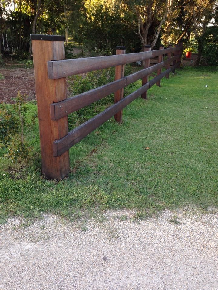 A Wooden Fence Is Sitting in The Middle of A Lush Green Field — Budget Timbers in North Lismore, NSW