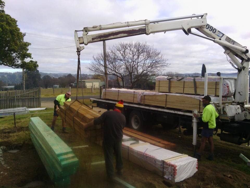 A Person Is Measuring a Piece of Wood with A Tape Measure — Budget Timbers in Byron Bay, NSW