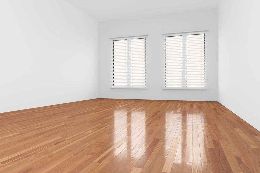 An Empty Room with A Wooden Floor and Two Windows — Budget Timbers in Murwillumbah, NSW