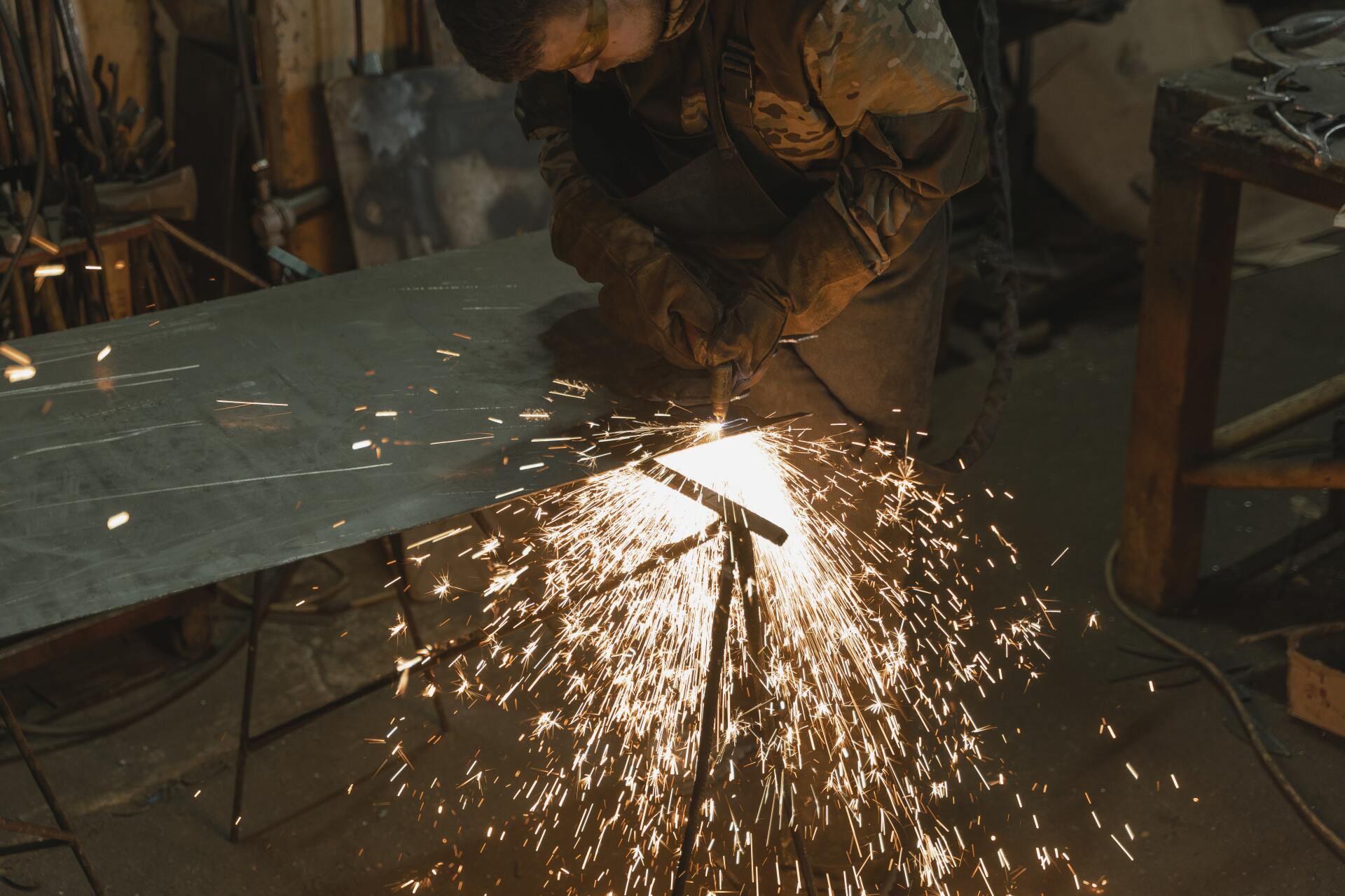 worker welding a piece of sheet metal