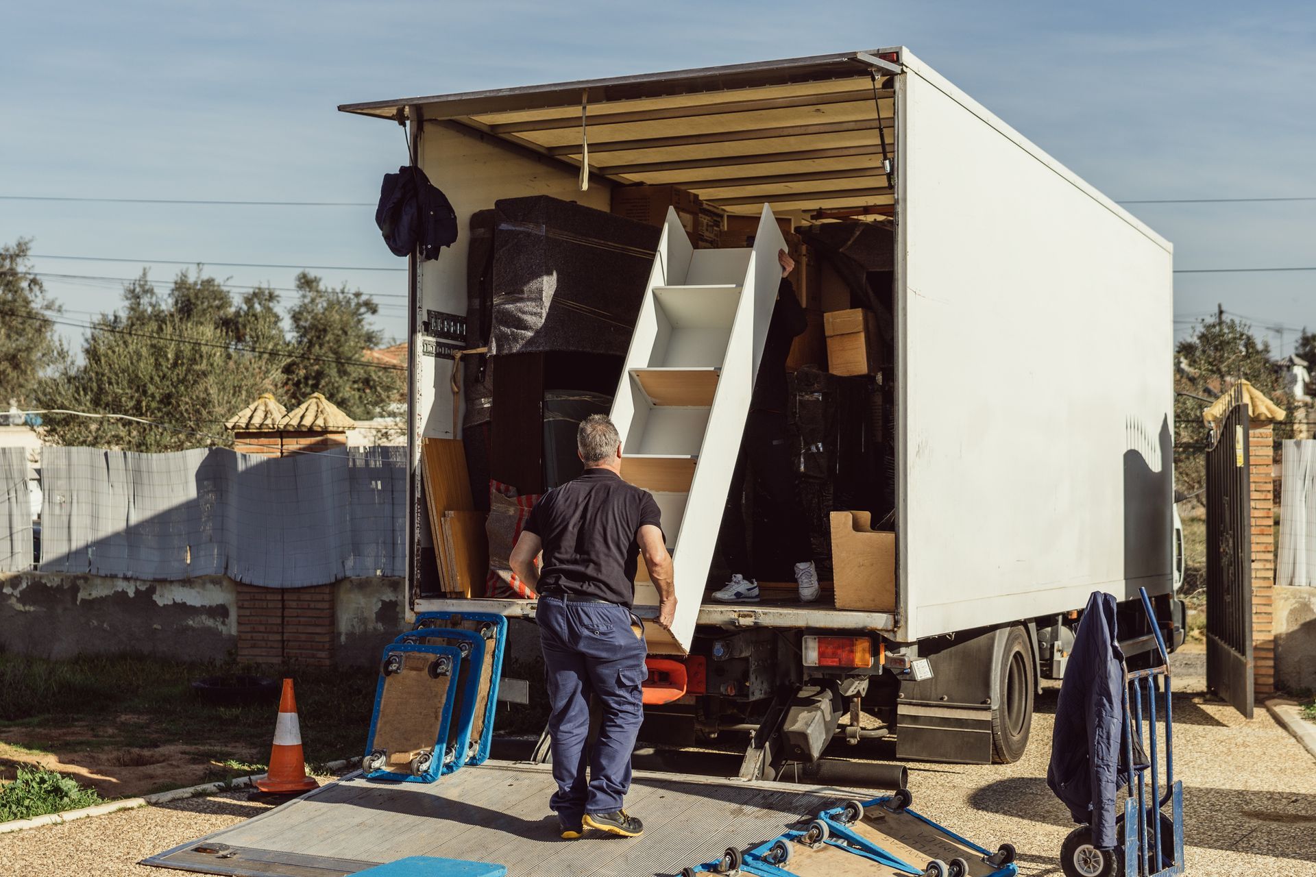 A man is loading furniture into a moving truck.