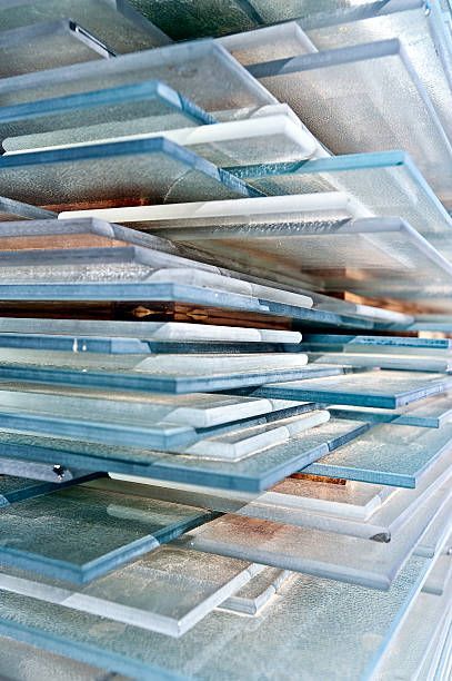 Stack of rectangular, translucent glass tiles with subtle blue and brown hues.