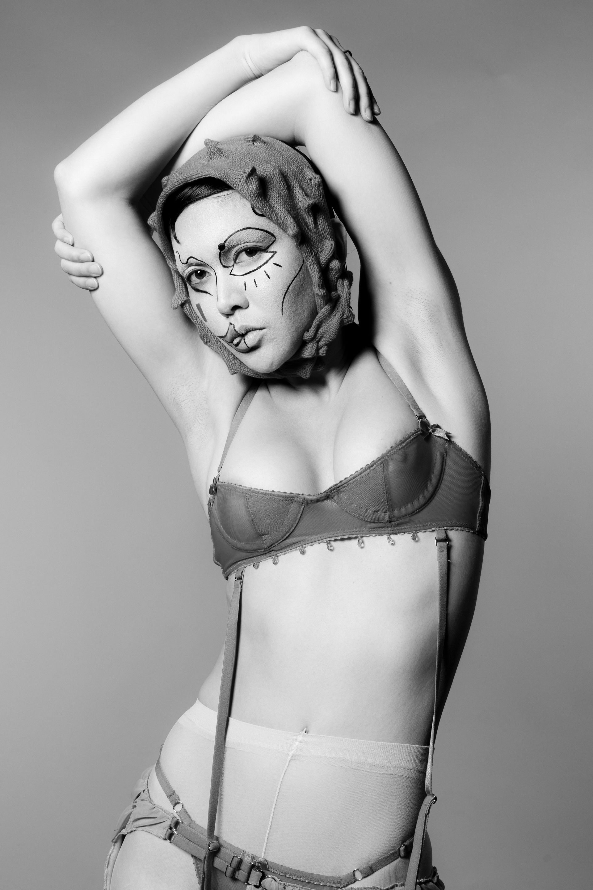 A black and white photo of a woman wearing lingerie