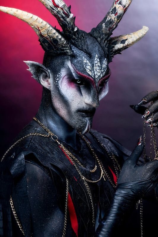 A man with horns on his head is holding something in his hand — Phoebe Lowenna In Gold Coast, QLD