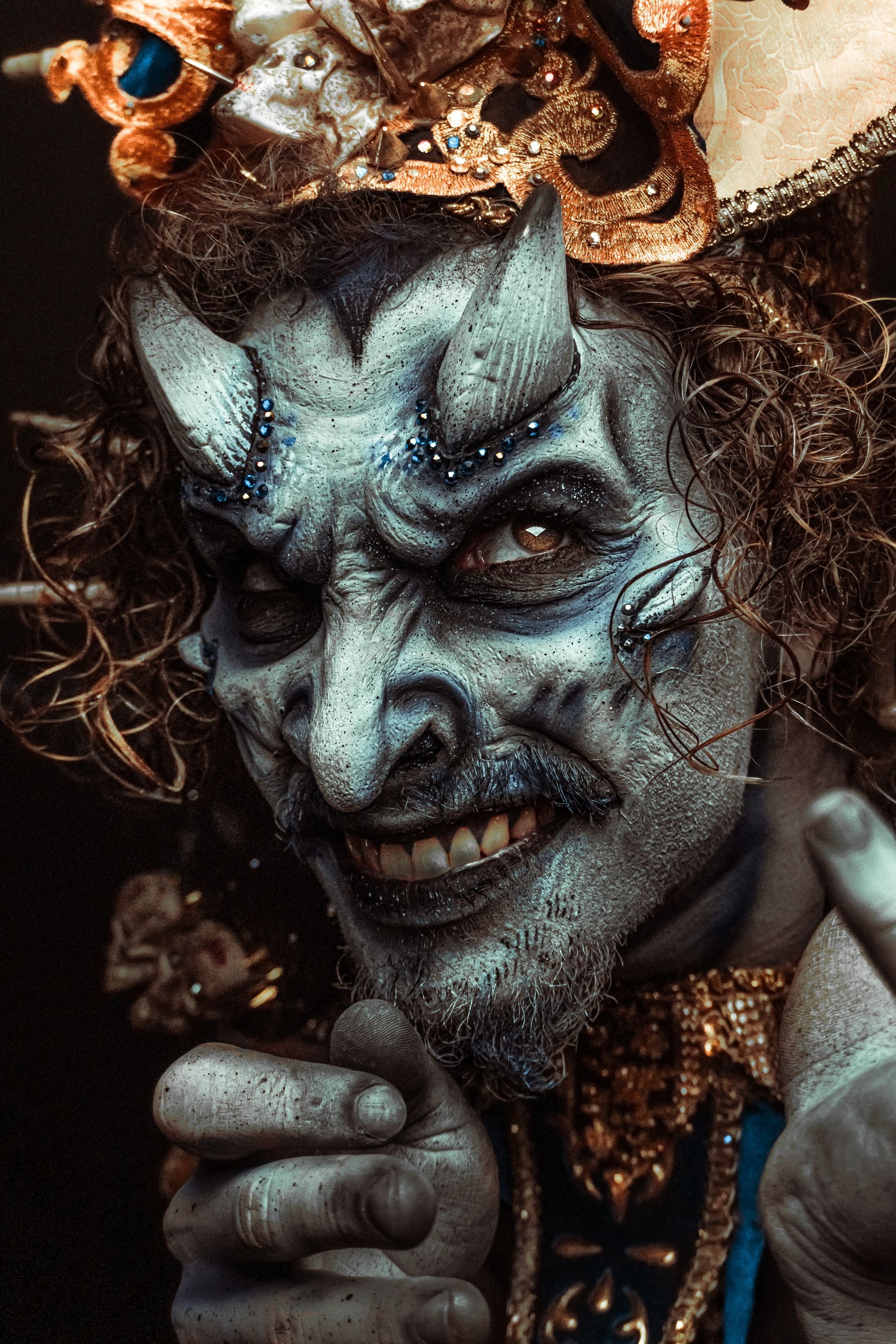 A close up of a person 's face with horns and a beard.