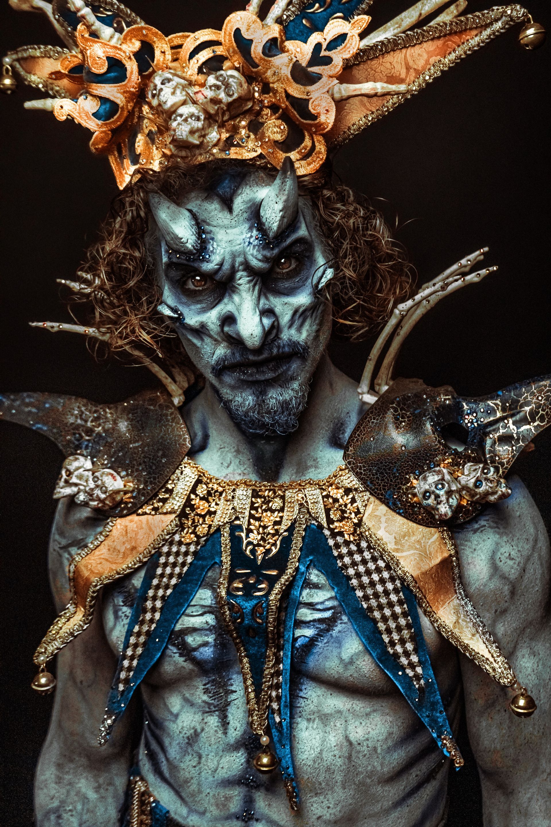 A man with body paint and a crown on his head