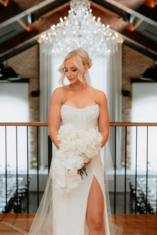 Woman Delicately Fixing Her Earrings — Hair And Makeup Artist - Phoebe Lowenna