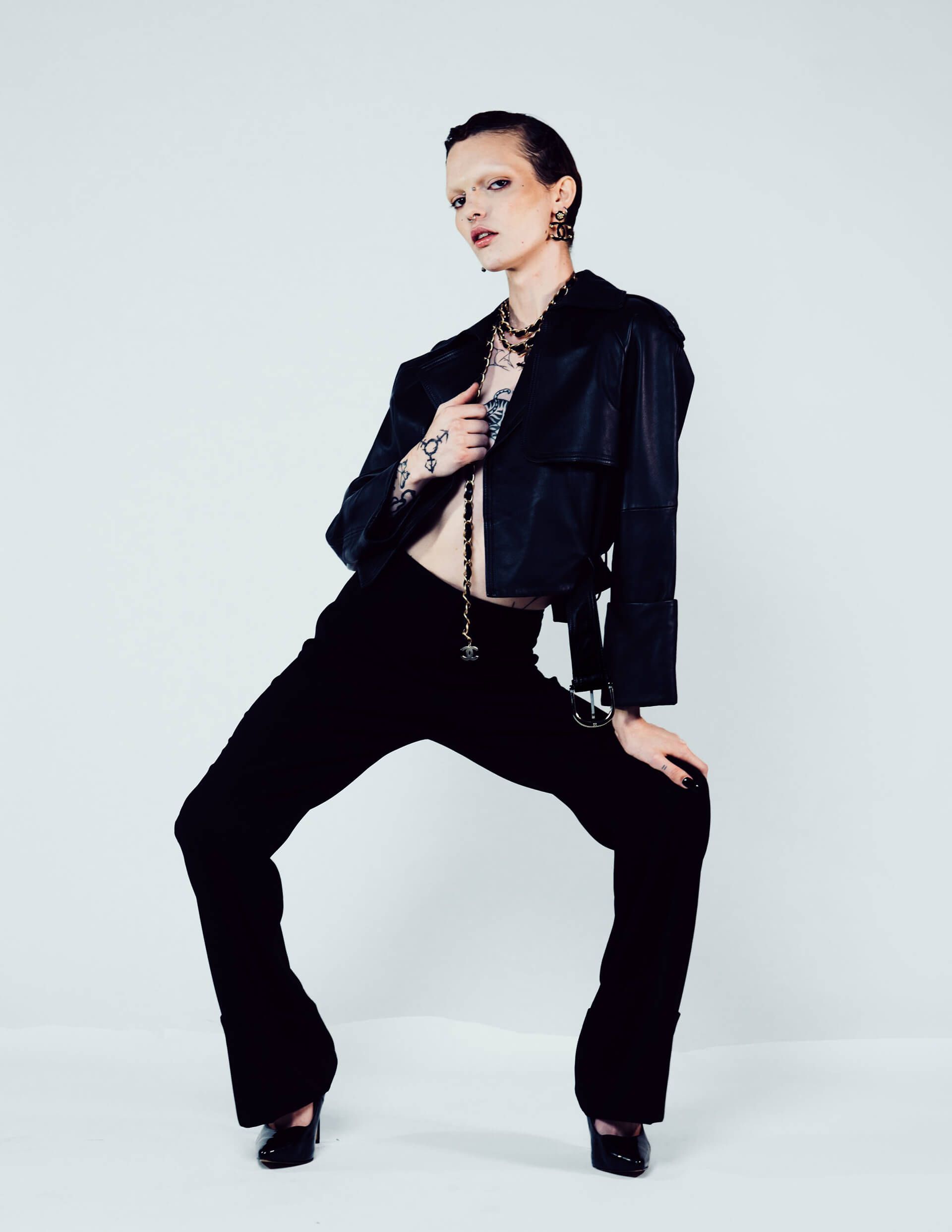 A woman is wearing a black jacket and black pants