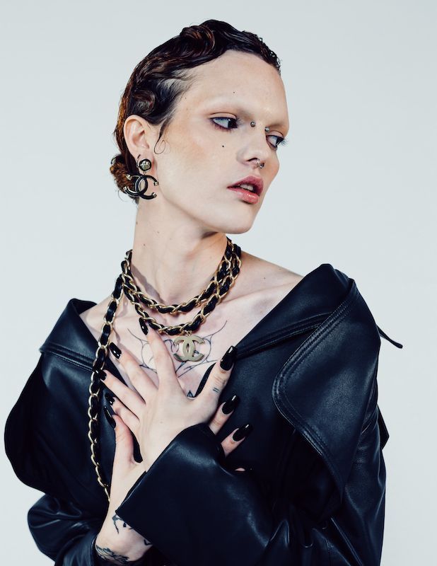 A woman wearing a black leather jacket and a necklace