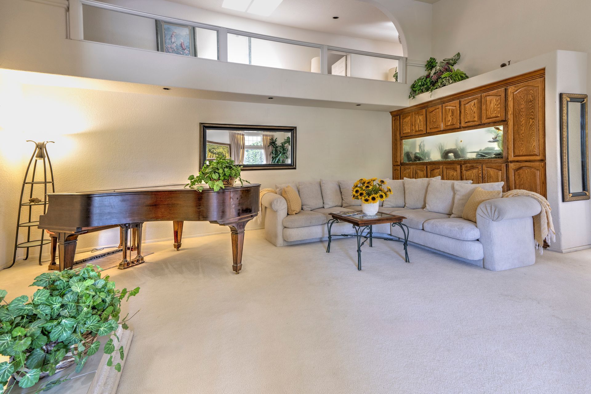 A dining room with a table and chairs and a wooden staircase.