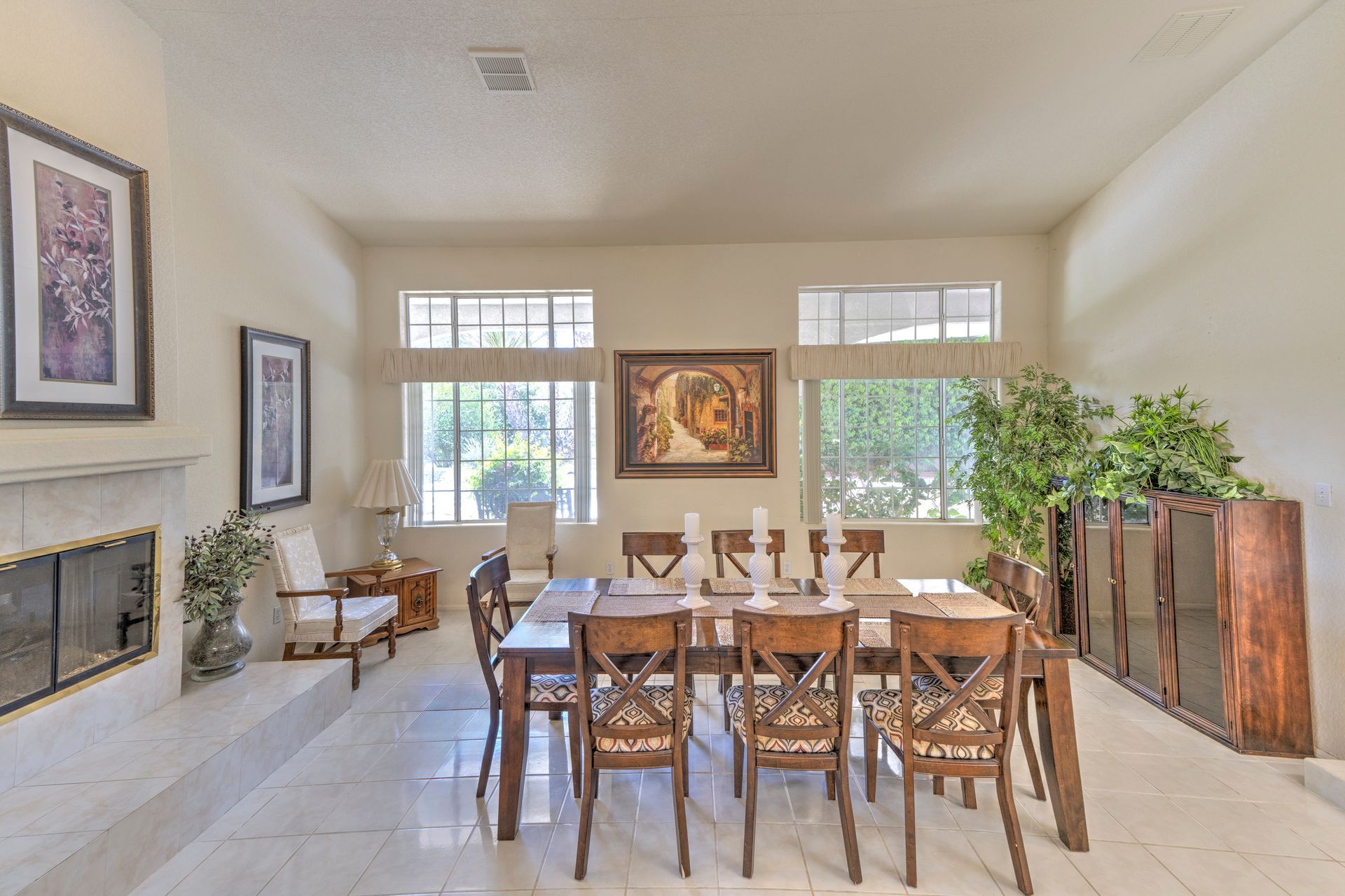 A patio with a lot of furniture and lights at night.