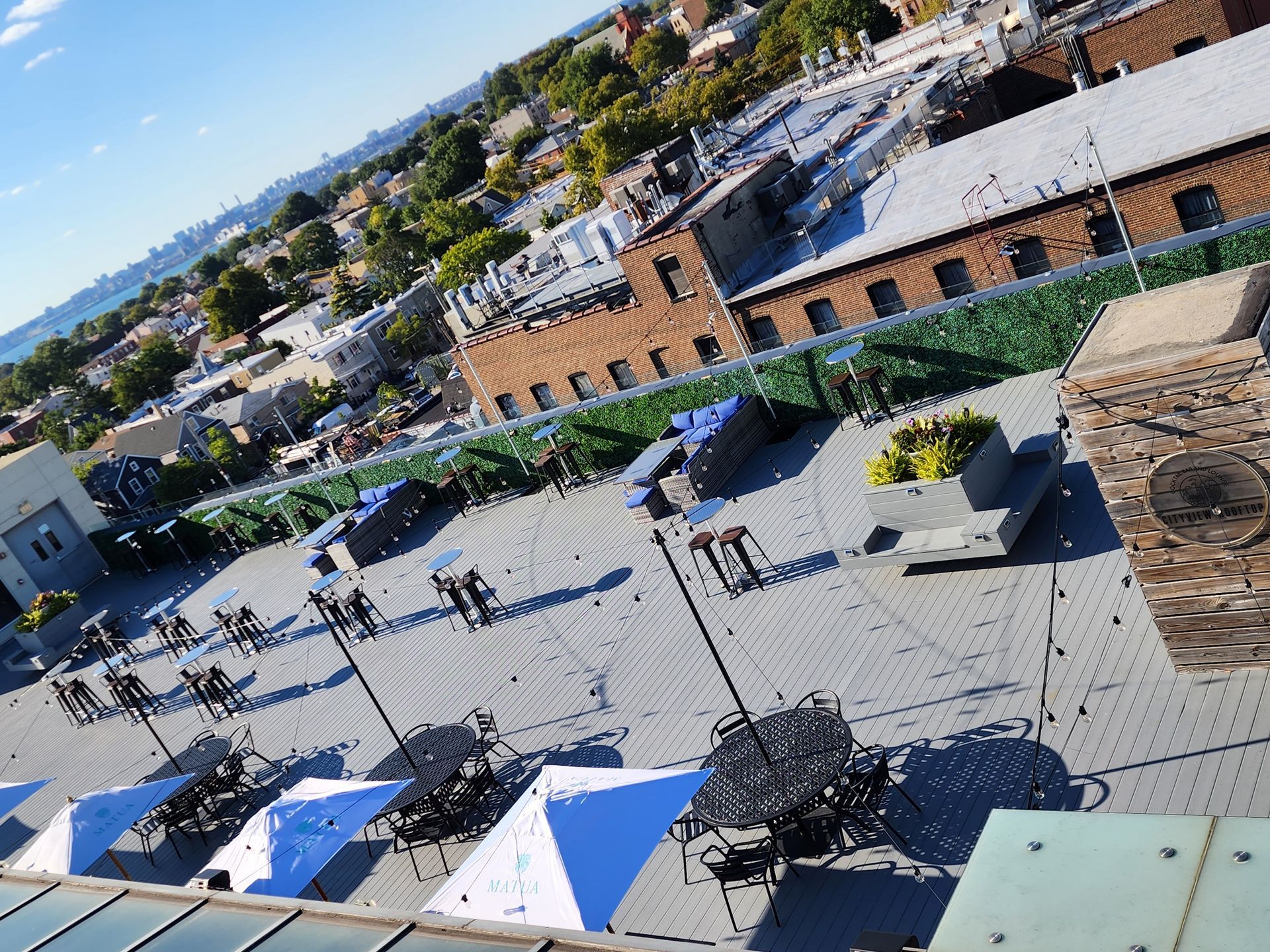 An aerial view of a rooftop area with umbrellas and chairs