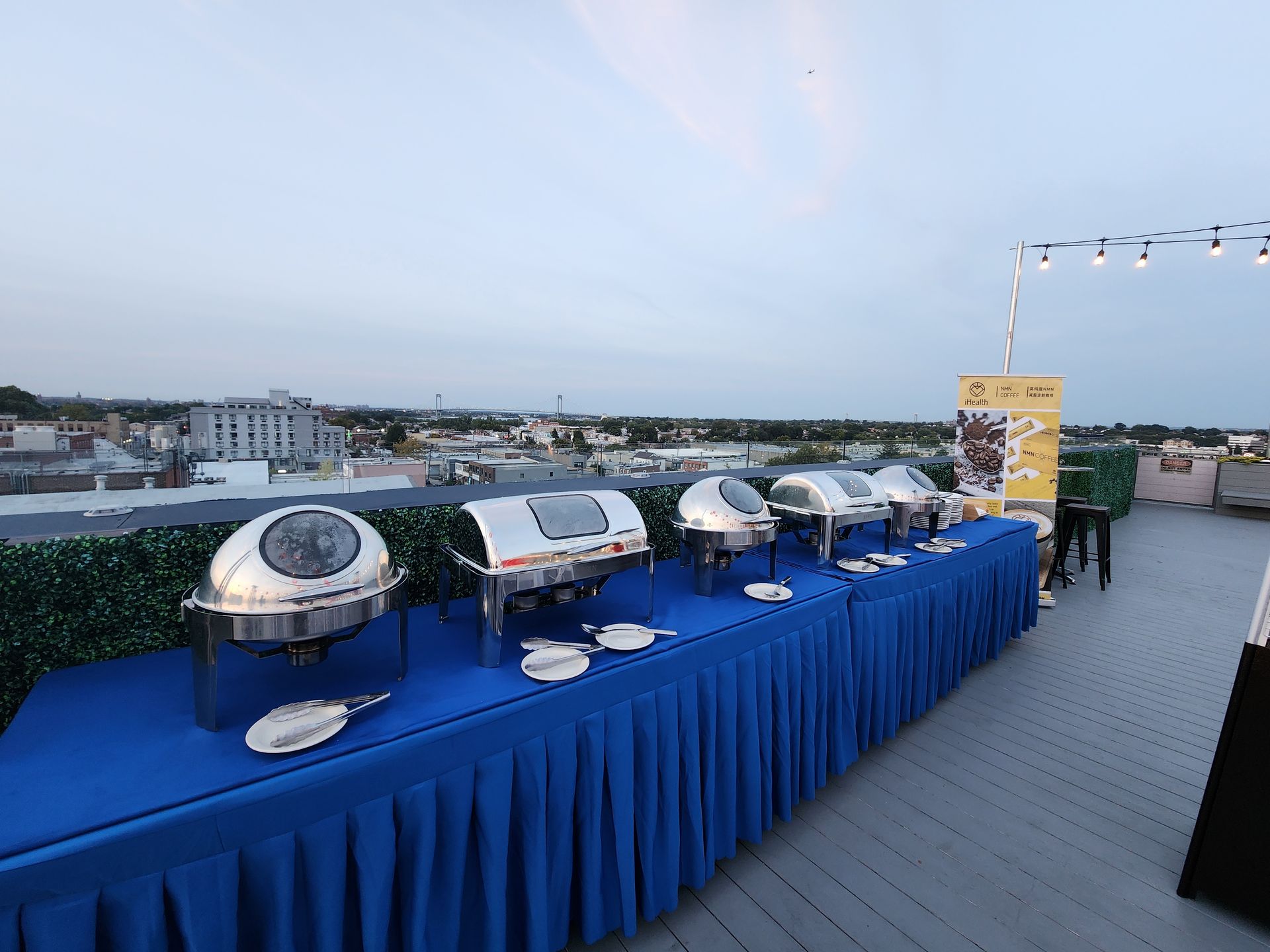 A long blue table with a lot of food on it