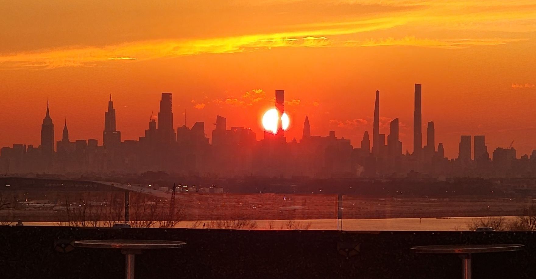 The sun is setting over the city skyline.