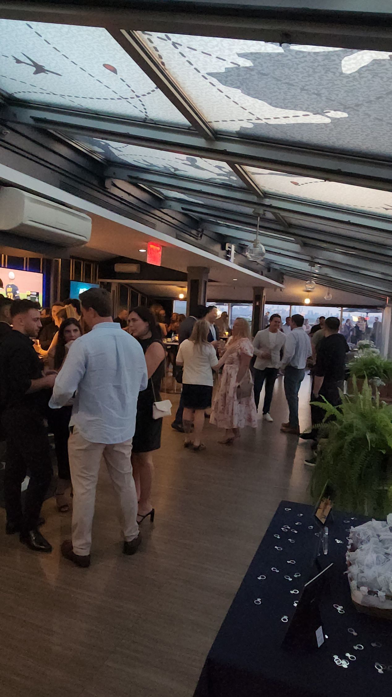 A group of people are standing in a room.