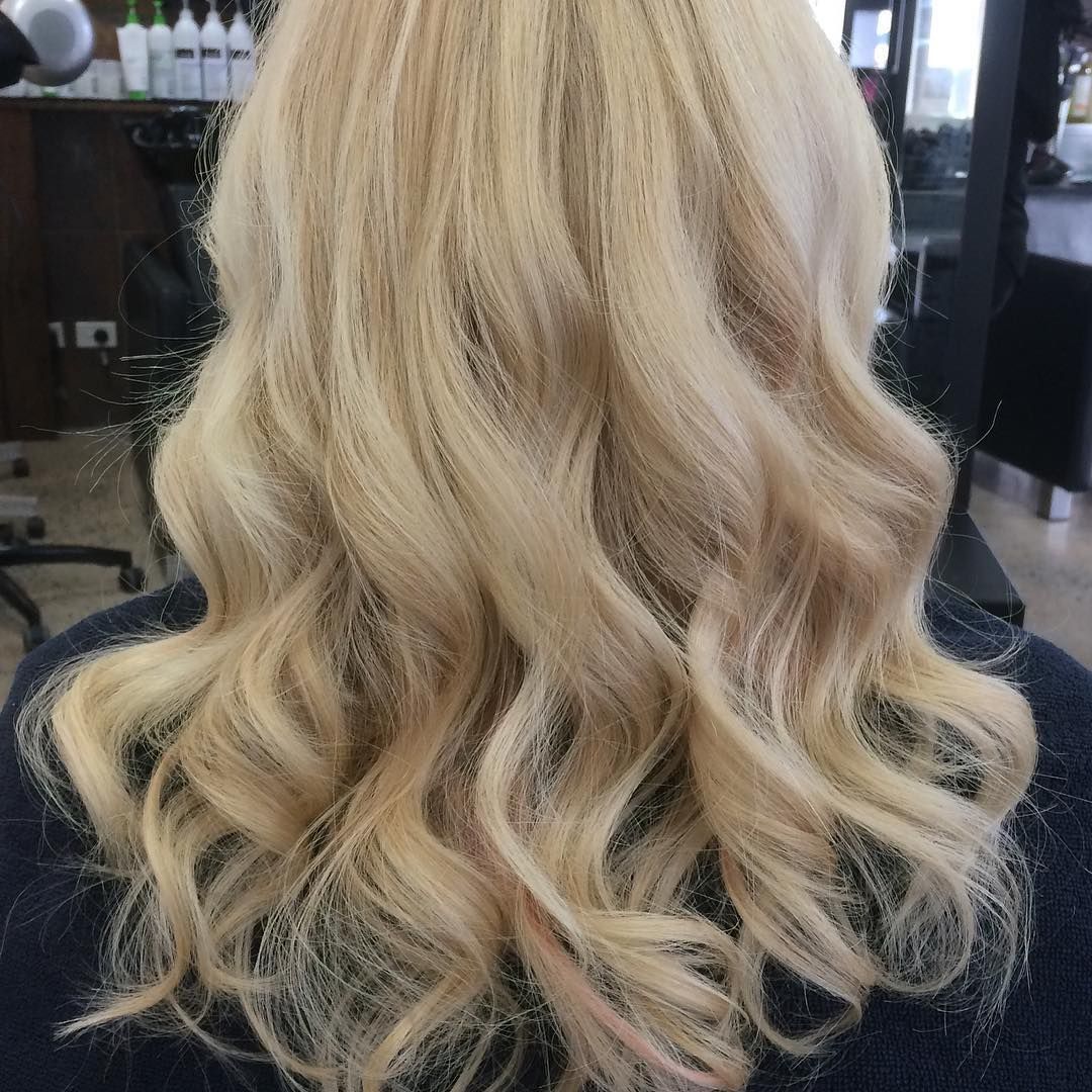 A woman with long red hair is wearing a mask.